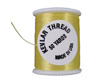 Yellow Kevlar thread spool with printed label and loose thread strand