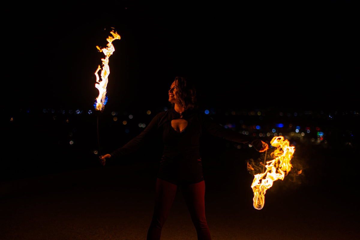 Fire poi with black braided cords and two burning flame ends
