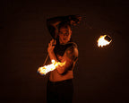 Fire poi set with flaming tips on chains held by performer