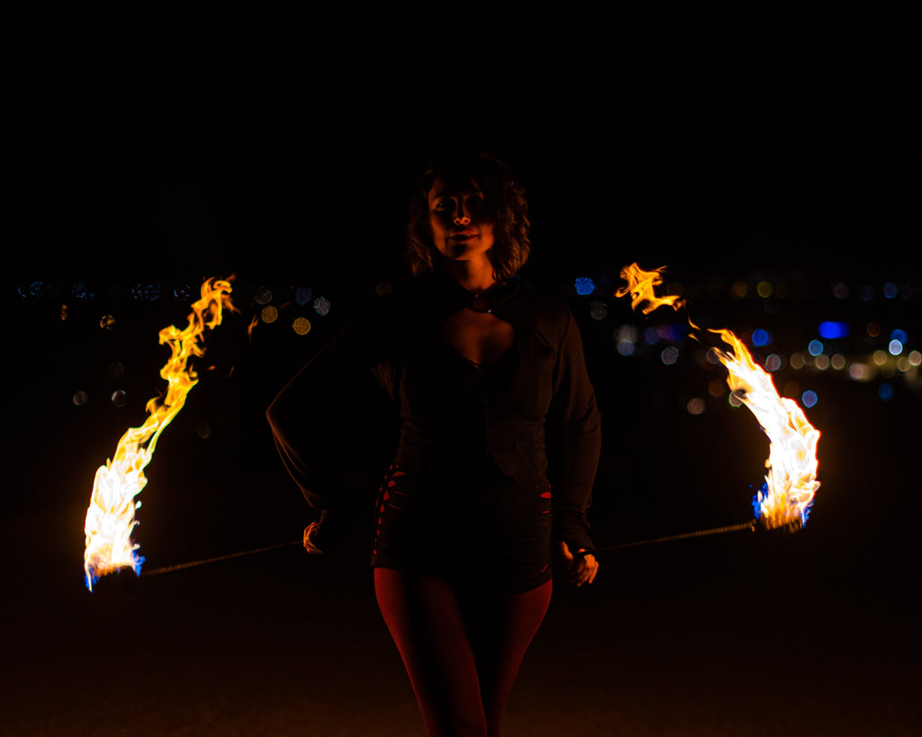 Fire poi show with black braided cords and two flame tips at the ends