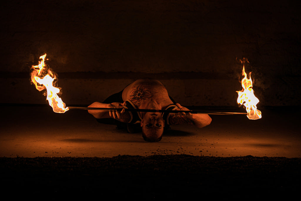 Fire staff with two ignited flames and black center grip wrap