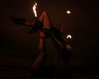 Flaming fire torch held overhead with a burning tip at the woven tan head