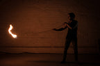Rope dart fire demonstration with burning flame head on extended rope