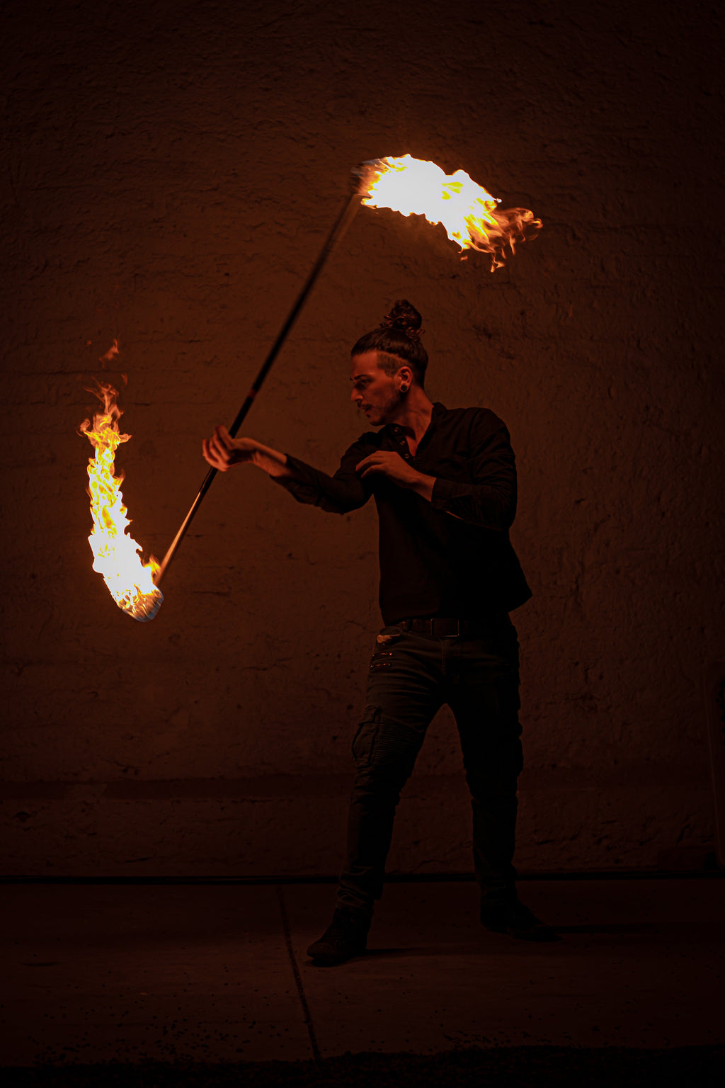 Fire staff with flames burning from both wick ends during use