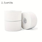 White athletic trainer tape roll pair with one loose roll angled in foreground