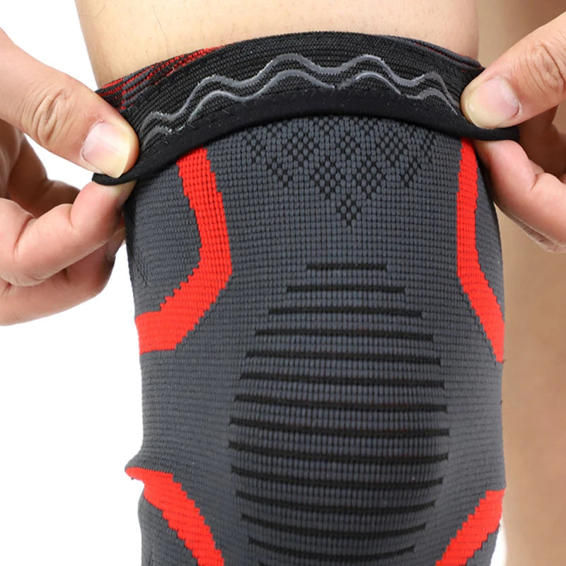 Black knee sleeve with red compression bands and ribbed support panels.