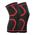Pair of black knee sleeves with red contour bands and textured support weave.