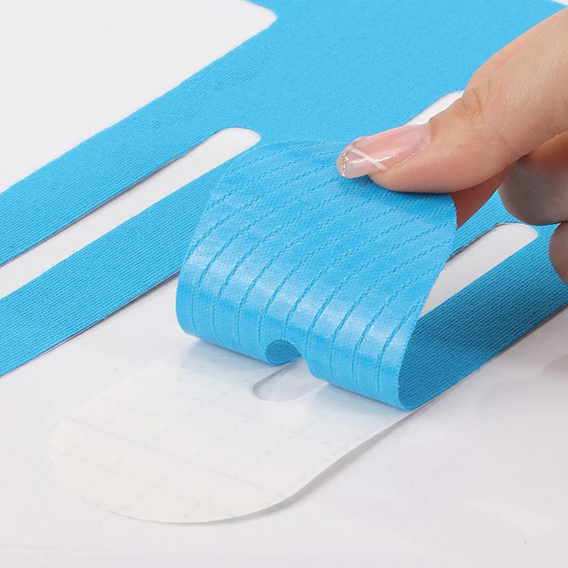 Blue kinesiology tape strip laid out flat with adhesive backing