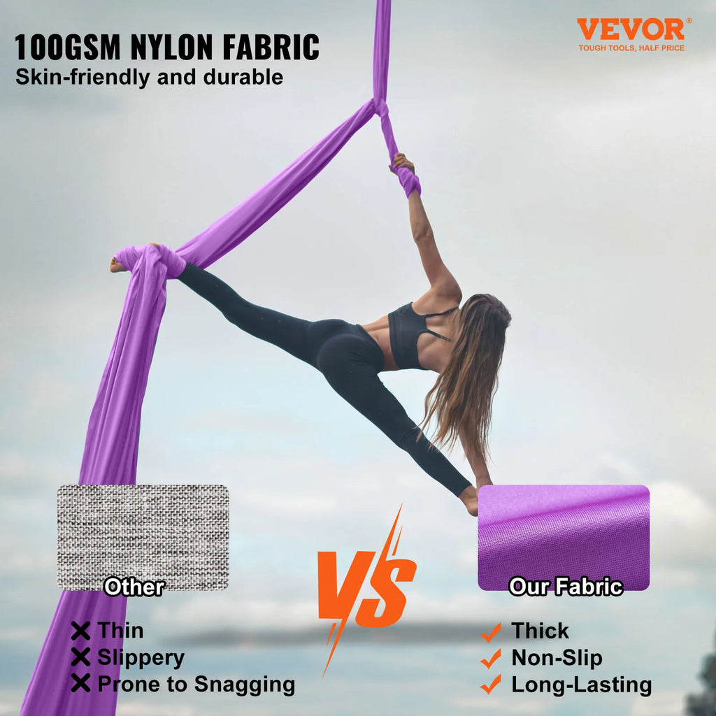 Purple aerial hammock silk sling for yoga, suspended from a ceiling strap