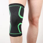 Black knee sleeve with neon green support bands and ribbed center section.