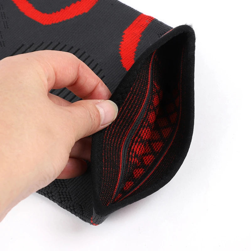 Knee sleeve corner detail showing black fabric with red accent stitching and grip weave.
