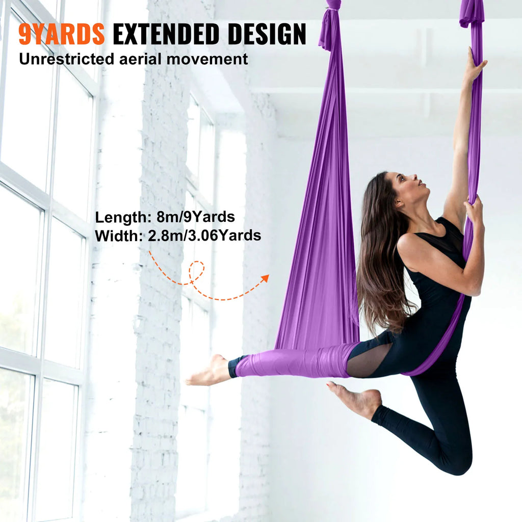 Purple aerial yoga hammock with long hanging silk for stretching and poses