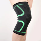 Black knee sleeve with green U-shaped support bands and ribbed design.