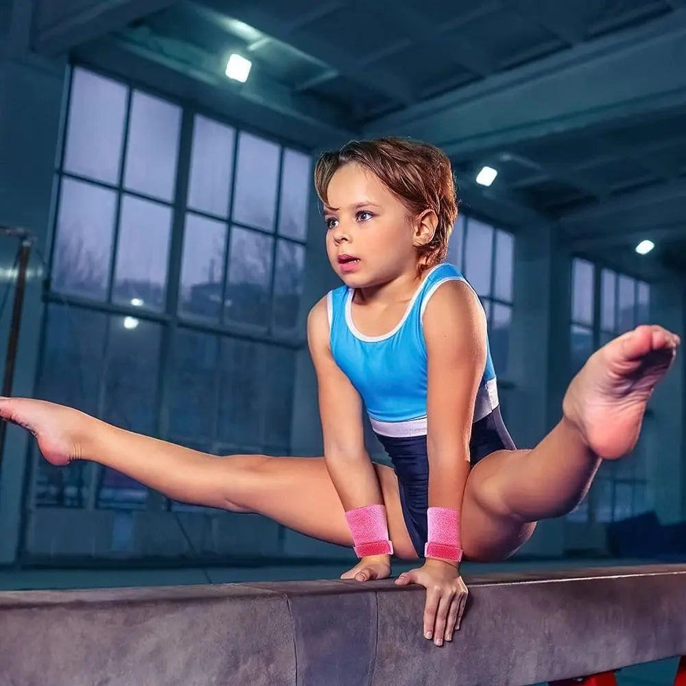 Child wearing pink aerial grip wristbands on both hands during play